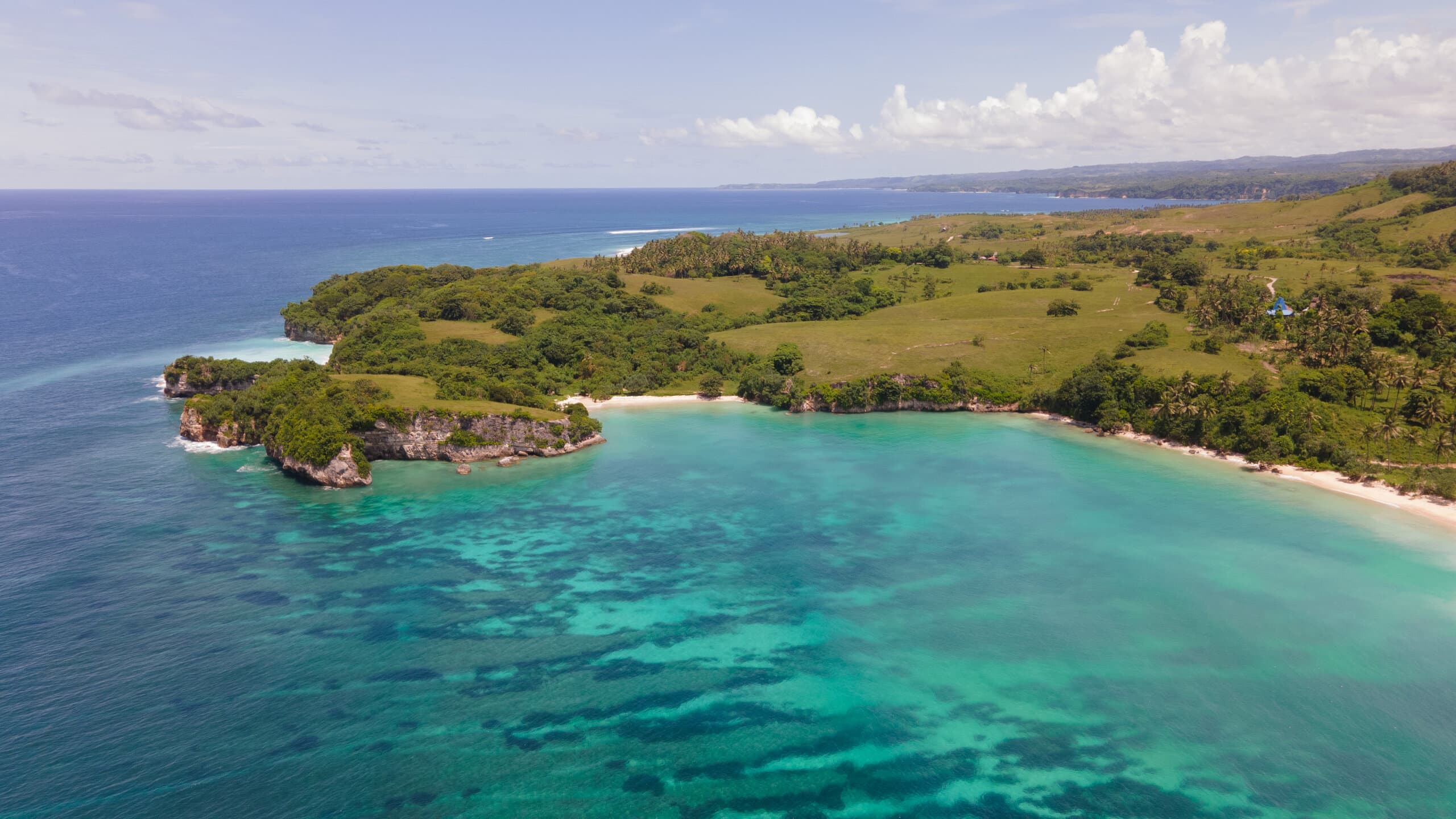 Aerial side-on view of Kerewe beach from the ocean